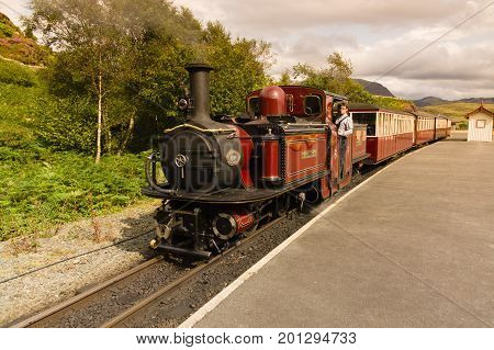Tanygrisiau Wales UK - August 22 2017: Narrow gauge Double Fairlie steam locomotive Merddin Emrys of the Ffestiniog Railway Company part of the heritage line that runs through the Snowdonia National Park