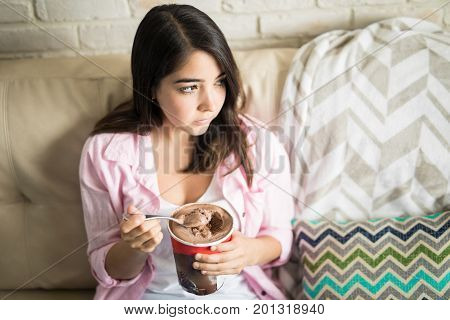 Woman Having Snack And Looking Upset