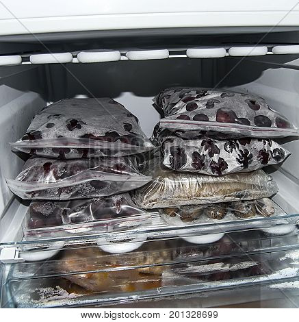 Freezing food in deep freeze, deep-freezing frozen fruit, deep freeze and food
