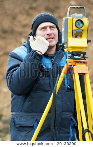 Surveyor worker make data collection with total station theodolite at construction site