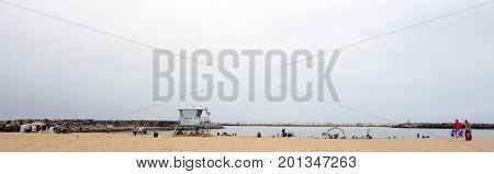 VENTURA CA USA - JULY 4 2013: Beachgoers enjoying holiday at Ventura city beach near Harbor Village Southern California