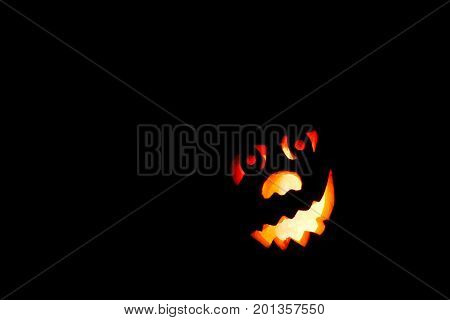 HappyHalloween pumpkin with scary face on black backgound