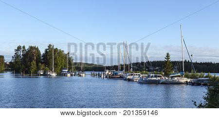 HEINOLA, FINLAND ON JULY 01. View of a marina this side a forest by the lakeside on July 01, 2017 in Heinola, Finland. Evening and sunshine. Editorial use.