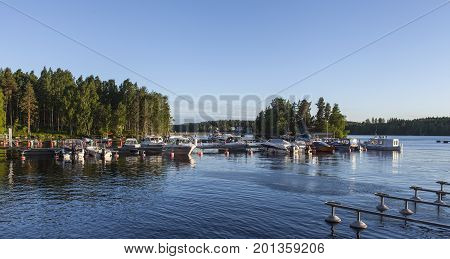 HEINOLA, FINLAND ON JULY 01. View of a marina this side a forest by the lakeside on July 01, 2017 in Heinola, Finland. Evening and sunshine. Editorial use.