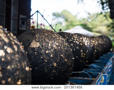 Cicle stone with thin golden paper call is Looknimit Thai traditional religion ceremony to set up boundary of temple or Wat.