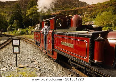 Tanygrisiau Wales UK - August 22 2017: Narrow gauge Double Fairlie steam locomotive Merddin Emrys of the Ffestiniog Railway Company part of the heritage line that runs through the Snowdonia National Park