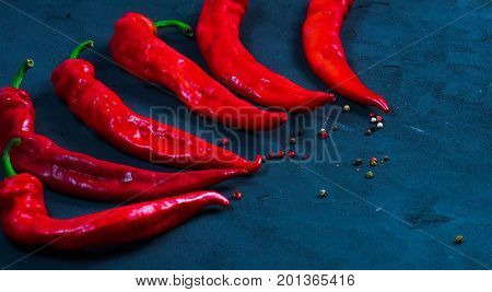 Red hot chili peppers on slate background