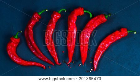 Red hot chili peppers on slate background