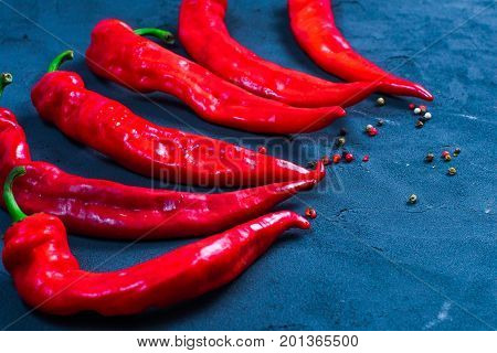 Red hot chili peppers on slate background
