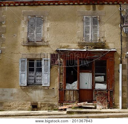 Delapidated shop front in rural central France