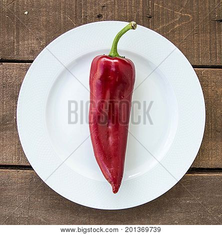 The most beautiful concept is Red fresh chilli on wood desk.