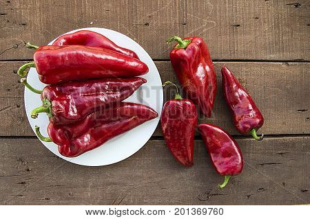 The most beautiful concept is Red fresh chilli on wood desk.
Red Hot Chili Peppers over wooden background