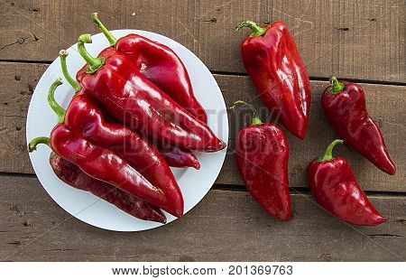 The most beautiful concept is Red fresh chilli on wood desk.
Red Hot Chili Peppers over wooden background