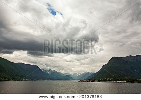 Mountains along the Romsdalsfjorden near Andalsnes under a cloudy sky Norway