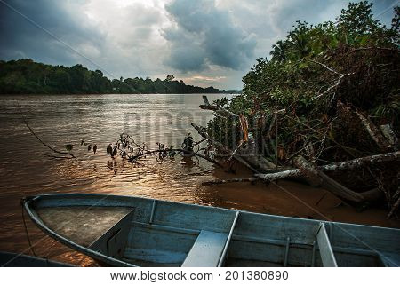 Kinabatangan River, Borneo, Sabah Malaysia. Evening Landscape Of Trees, Water And Boats.