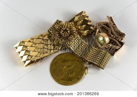 luxurious and expensive golden bracletes rings and coin. Luxury Jewellery.