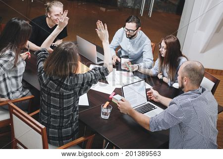 Group Of Six Coworking People Meeting In Office. Startup Team Brainstorming. Teamwork On New Project