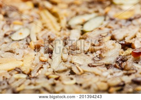 Food textures and patterns concept. Detailed closeup of whole grain bread with many big grains