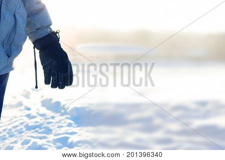 hand in warm gloves on background of snow. copy space