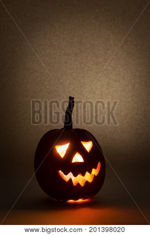 HappyHalloween pumpkin with scary face on black backgound