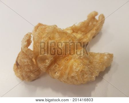 several pork rhinds sitting on a white surface