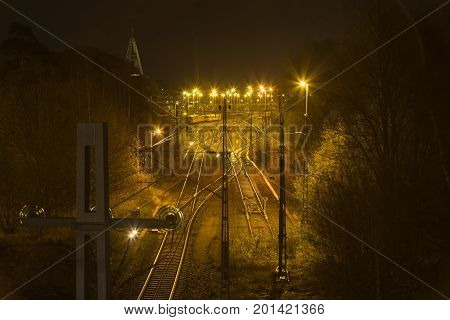 Trainyard in the night with a church in the background