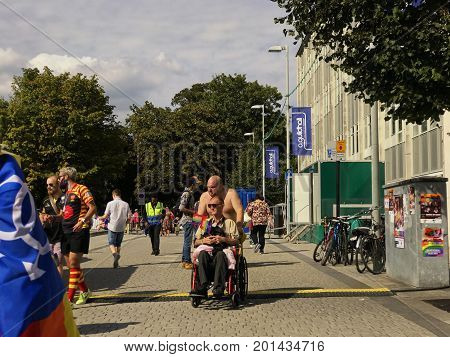 SOUTHAMPTON UK - August 26 2017: Southampton Pride 2017 City's second annual Pride event in Southampton UK. Man pushing man in wheelchair.