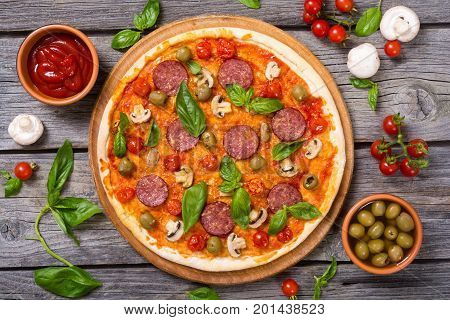 Italian pizza and ingridiend fod baking on table . Top view