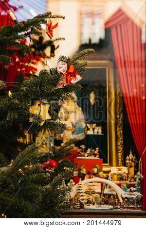 Christmas fir-tree decorated with toys on the foreground. Selective focus. Christmas background decorations.