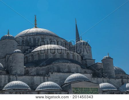 Domes of Sultanahmet Cami (Blue Mosque) in Istanbul with blue sky on the background