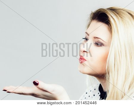 Coquet Blonde Woman Sending Air Kiss