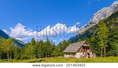 Mountain cabin, hut in European Alps, located in Robanov kot, Slovenia, popular hiking and climbing place with picturescue view