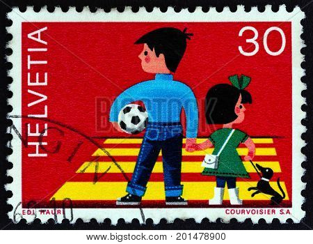 SWITZERLAND - CIRCA 1969: A stamp printed in Switzerland shows children crossing road, circa 1969.