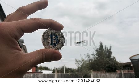Silver Bitcoin Coin Near Airplane