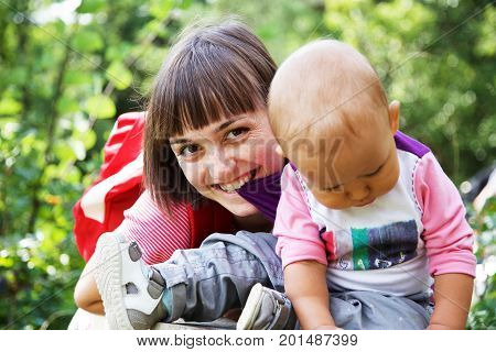 Happy family moments - Mother and child have a fun. Pretty young mother laugh and looking at camera