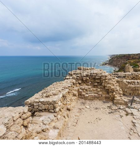 Ruins of the crusader fortress of the city Arsour in Israel. Dunes on the shore of the Mediterranean sea at Israeli Apollonia national park.