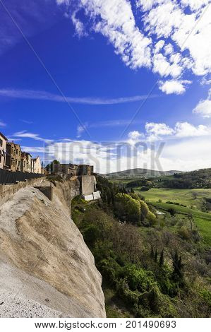 Village Trevinano located upon a hill near the borders of Lazio with the Tuscany and Umbria. Italian landscape with forests and meadow early in the morning. Agriculture in Italy fields and pastures.