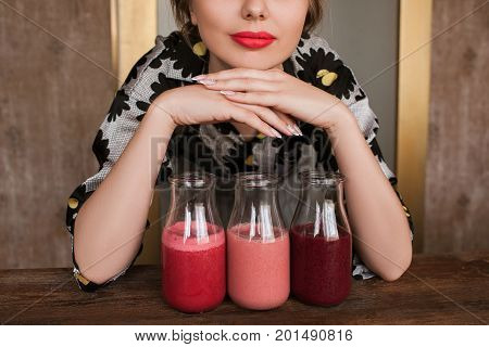 Housewife preparing fresh smoothies at home. Fruit drinks from strawberry, cherry and wineberry, refreshment in hot weather and summer period, healthy food close up