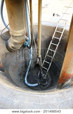 Pump sump in the tank of a sewage treatment plant, which was emptied for work