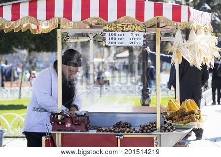 ISTANBUL, TURKEY - 1 APRIL , 2017:Sellers of fried corn chestnuts in the streets of Istanbul in Turkey