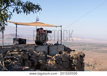 Golan Heights Israel August 27 2017 : The peacekeeper from the UN forces looks toward Syria being on a fortified point on Mount Bental on the Golan Heights in Israel.