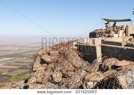 Golan Heights Israel August 27 2017 : The peacekeeper from the UN forces looks toward Syria being on a fortified point on Mount Bental on the Golan Heights in Israel.