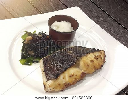 Smoked fish by charcoal stove with green fresh seaweed and chopped smash radish are delicious and healthy Japanese food.