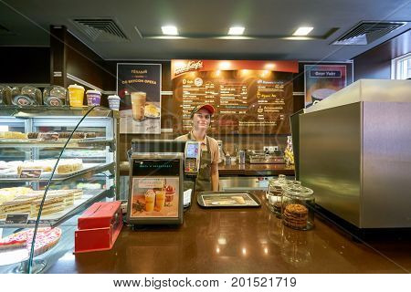 SAINT PETERSBURG, RUSSIA - CIRCA AUGUST, 2017: cashier at McCafe in Saint Petersburg. McCafe is a coffee house style food and drink chain, owned by McDonald's.