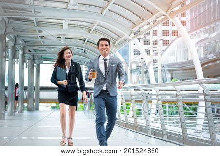 Businessman and businesswoman walking with happiness mood face Happiness conscept Business concept