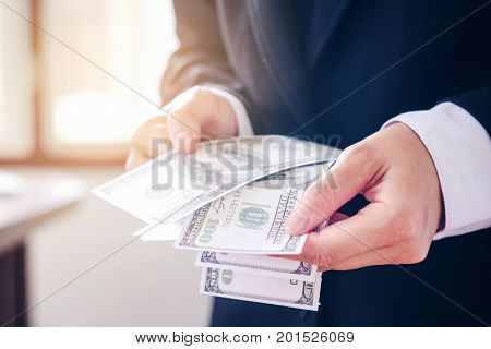 Business man holding dollar bills Saving money concept