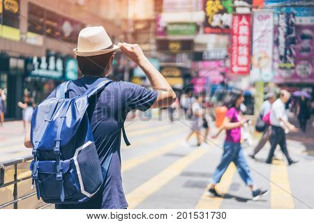 Young man traveler is visiting at Mongkok in Hong Kong.