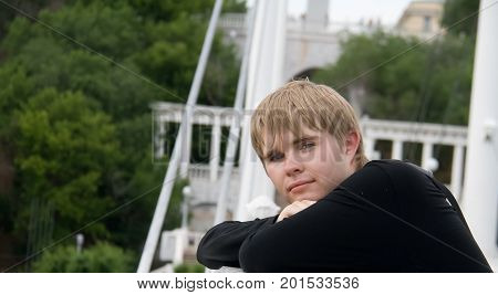 Portrait of attractive young man outdoors, looking at camera.
