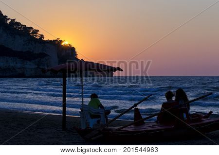 Family watching sunset on a lifeguard boat. for vacation and summer holiday concept