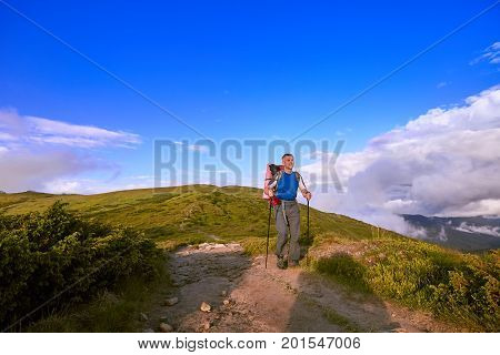 Hiking in the mountains with a backpack in the summer.